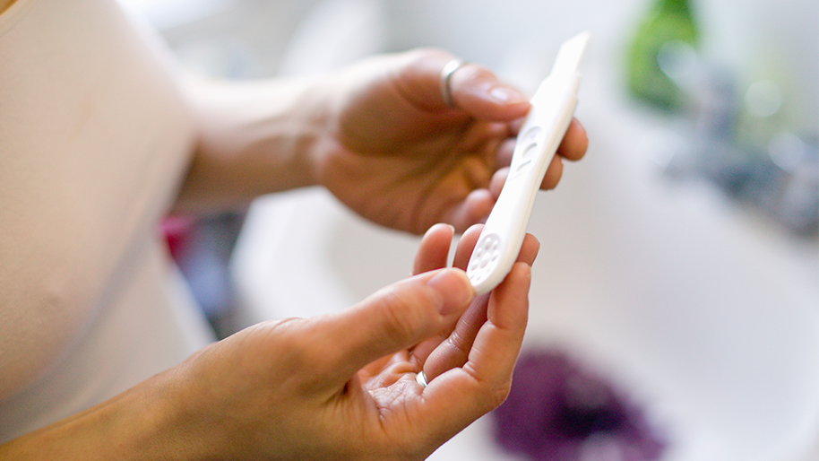 Hand holding a pregnancy test