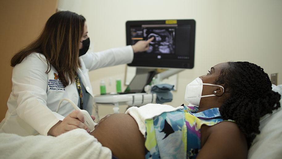 Allissa Carver performing an ultrasound on an expectant mom