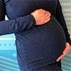 Pregnant woman with her hand on her abdomen
